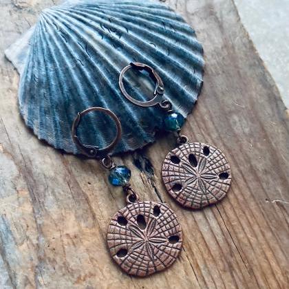 Copper Sand Dollar Earrings With Blue Crystal..