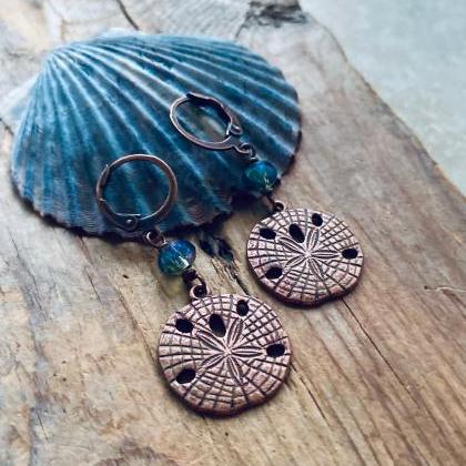 Copper Sand Dollar Earrings With Blue Crystal..